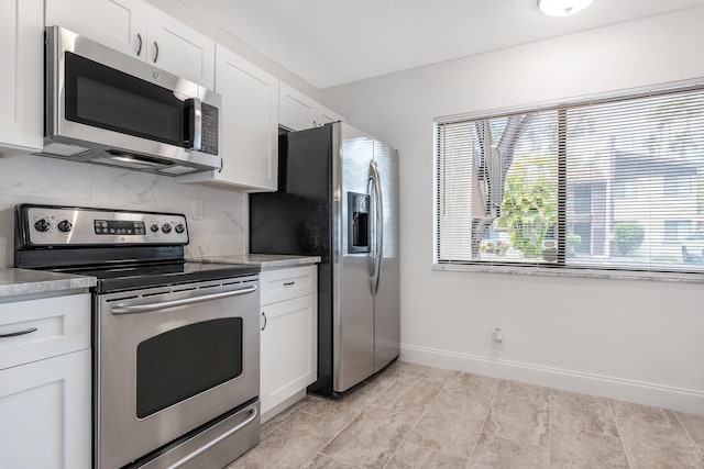 kitchen featuring white cabinetry, stainless steel appliances, and tasteful backsplash