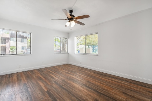 empty room featuring ceiling fan and dark hardwood / wood-style floors