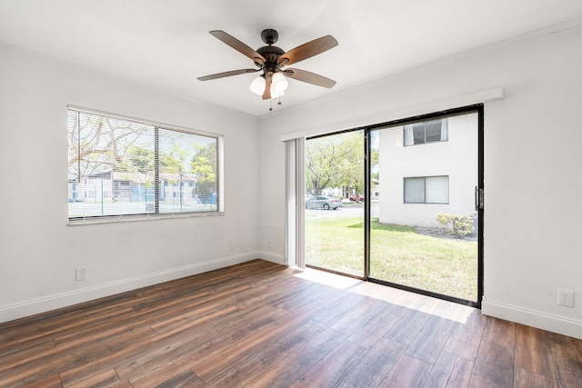 unfurnished room with ceiling fan and dark wood-type flooring