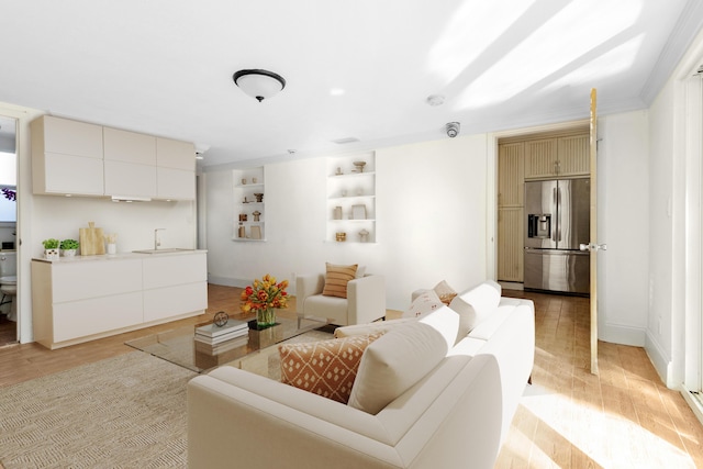 living room with sink and light hardwood / wood-style flooring