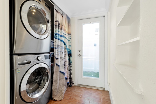 washroom featuring crown molding and stacked washing maching and dryer