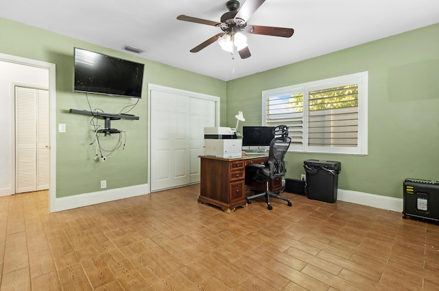 home office with ceiling fan and light hardwood / wood-style floors