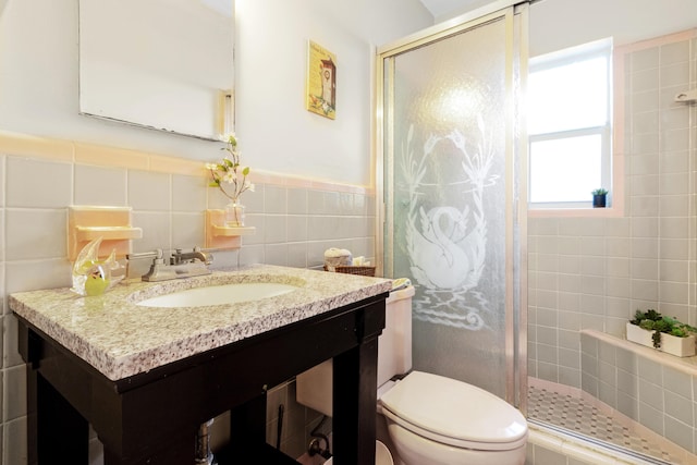 bathroom featuring vanity, tile walls, toilet, and walk in shower