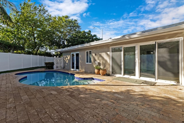 view of swimming pool with a patio area and french doors