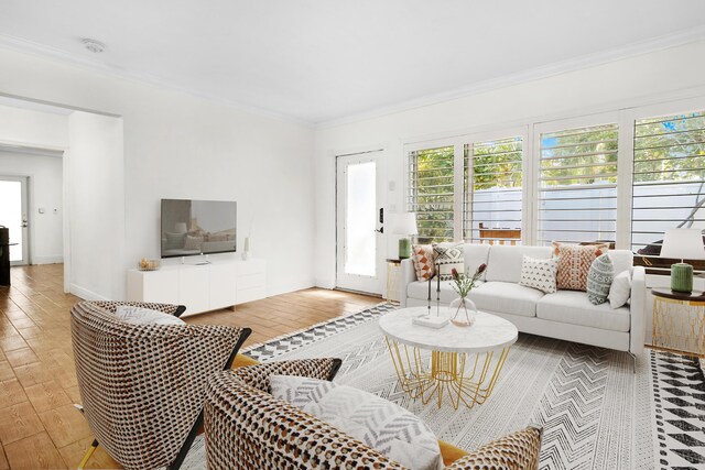 interior space featuring crown molding, light hardwood / wood-style floors, and a healthy amount of sunlight