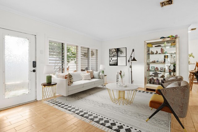 living room featuring ornamental molding and light hardwood / wood-style flooring