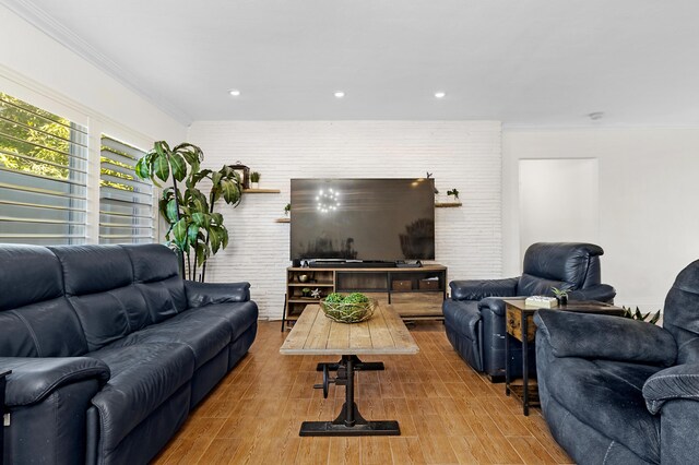 living room with a notable chandelier and crown molding