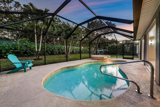 pool at dusk with an in ground hot tub, glass enclosure, and a patio