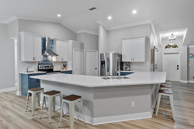 kitchen featuring a kitchen breakfast bar, vaulted ceiling, and white cabinets