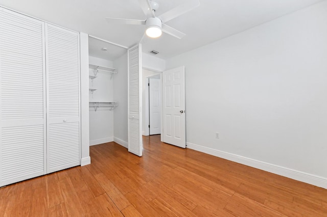 unfurnished bedroom featuring ceiling fan, a closet, and light wood-type flooring