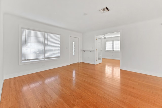 unfurnished living room with light wood-type flooring and ceiling fan