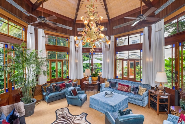 sunroom / solarium featuring plenty of natural light, lofted ceiling with beams, and a chandelier