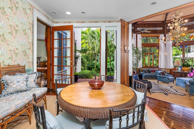 dining space featuring hardwood / wood-style flooring, a healthy amount of sunlight, and ornamental molding