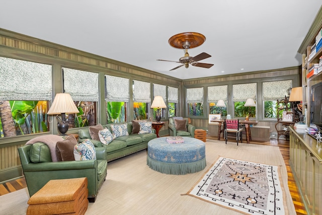 sunroom featuring ceiling fan