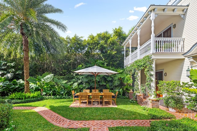 view of yard featuring a patio area and a balcony