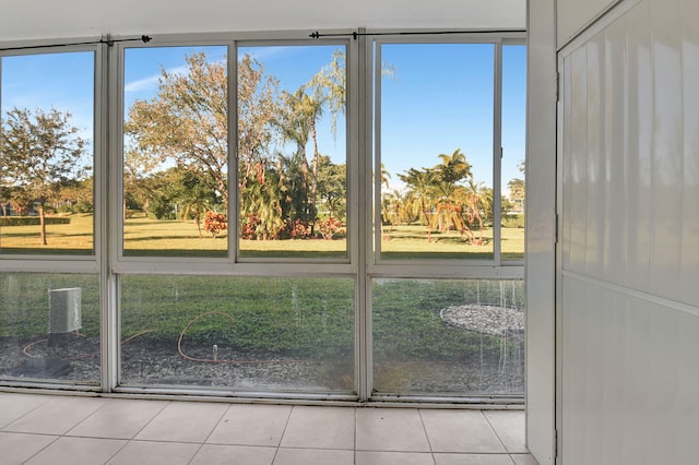 doorway to outside with light tile patterned floors and a wealth of natural light