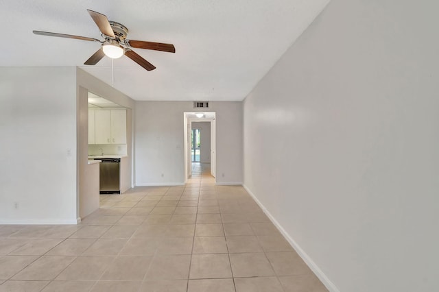 tiled spare room featuring ceiling fan