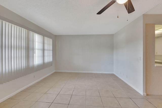 spare room with light tile patterned floors and ceiling fan