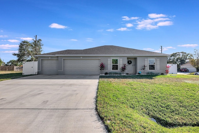 single story home with a front yard and a garage