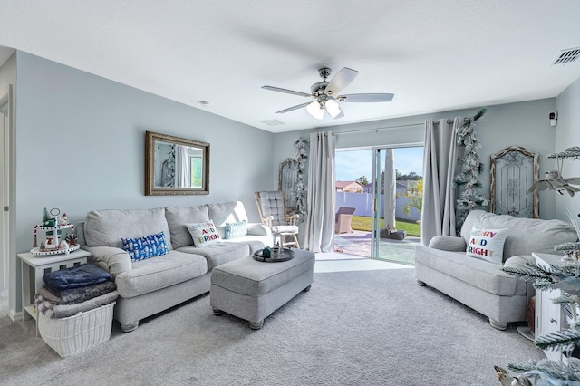 living room featuring ceiling fan and carpet