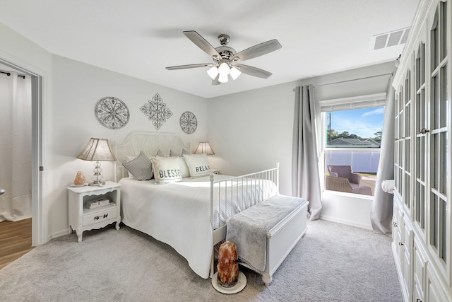 carpeted bedroom with ceiling fan and french doors