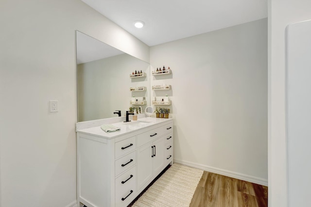 bathroom featuring hardwood / wood-style floors and vanity