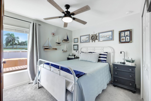 carpeted bedroom featuring ceiling fan and a closet