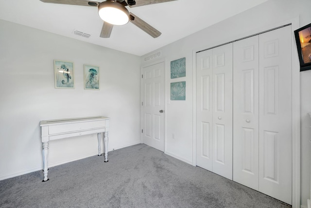 unfurnished bedroom with carpet flooring, a closet, and ceiling fan