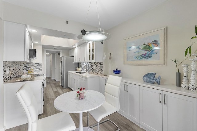 dining area with sink and light hardwood / wood-style flooring