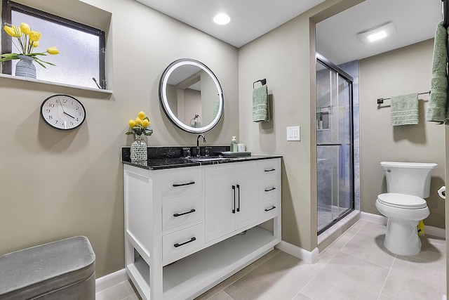 bathroom featuring tile patterned flooring, vanity, toilet, and a shower with door