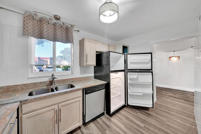 kitchen with light brown cabinetry, stainless steel dishwasher, sink, pendant lighting, and light hardwood / wood-style floors