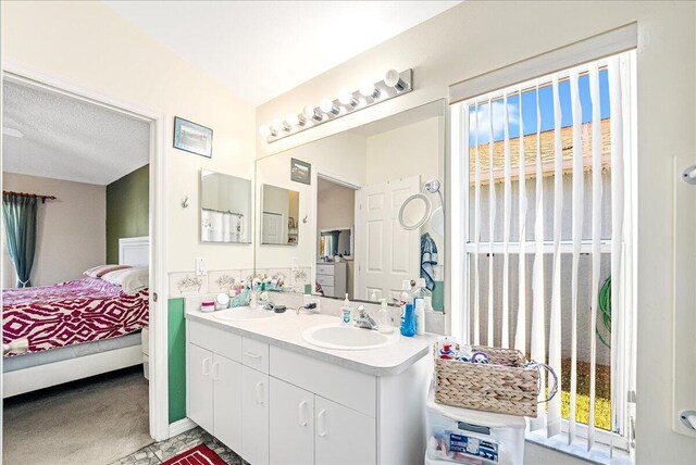 bathroom with vanity and a textured ceiling