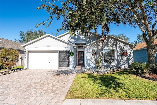 ranch-style house featuring a garage and a front lawn