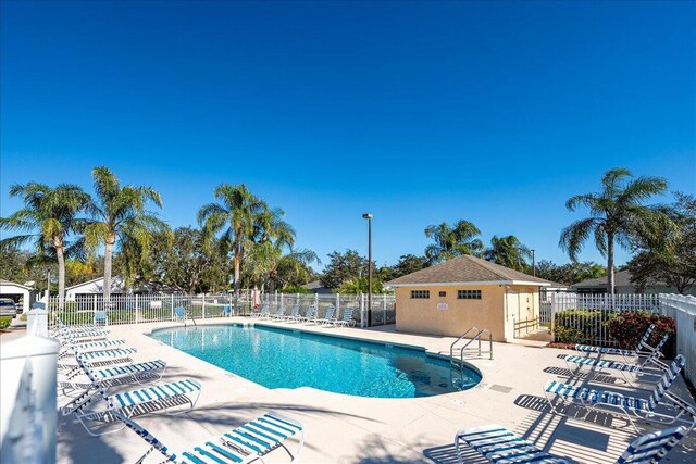 view of pool featuring a patio area and an outdoor structure