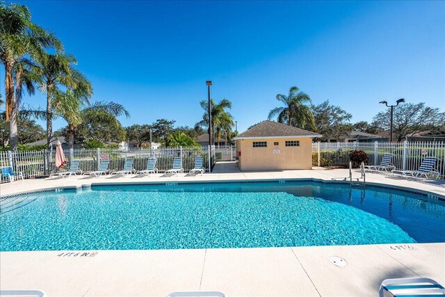 view of pool with an outdoor structure and a patio