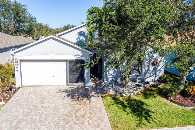 view of front of home with a garage and a front yard