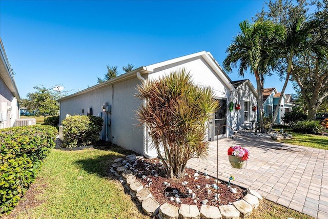 view of home's exterior featuring a patio and a lawn