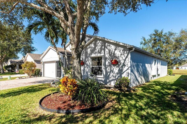 view of front of property with a front yard and a garage