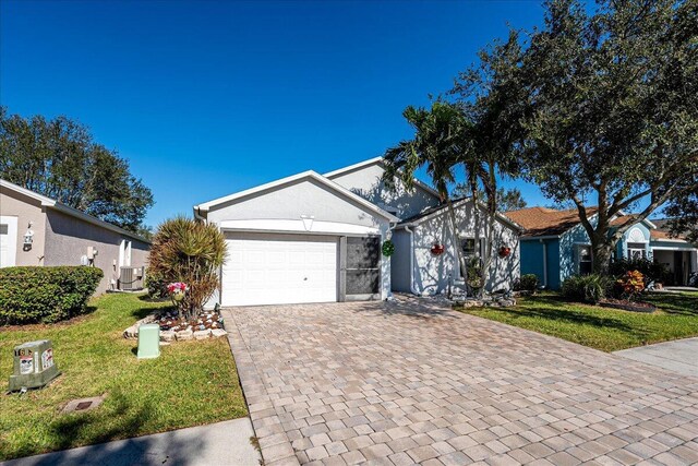 ranch-style house with central air condition unit, a front yard, and a garage