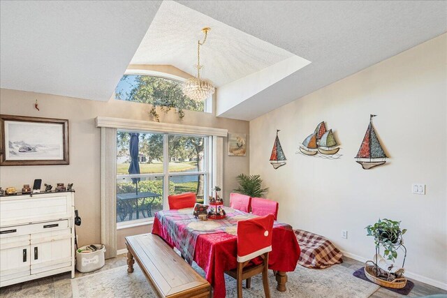 dining space featuring a textured ceiling, a chandelier, and vaulted ceiling