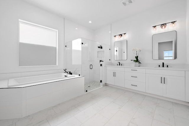 bathroom with vanity and independent shower and bath