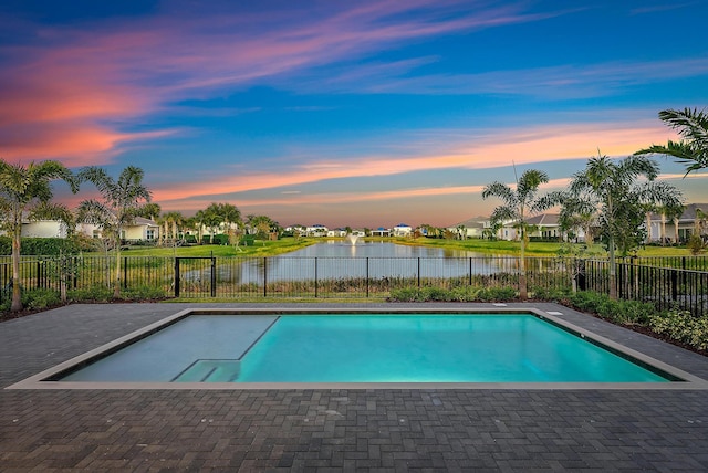 pool at dusk with a water view