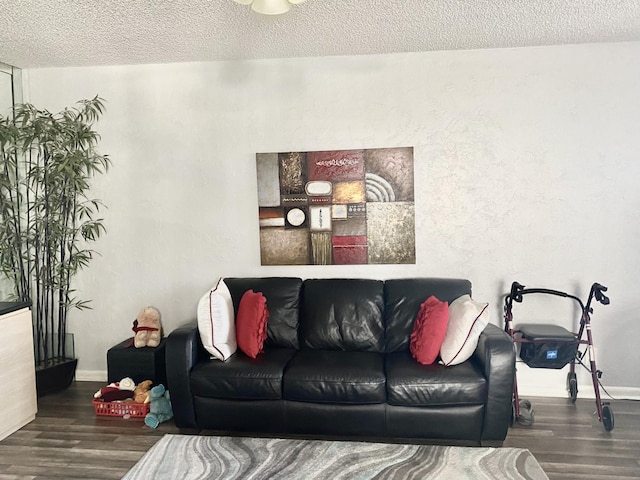 living room featuring a textured ceiling and dark wood-type flooring