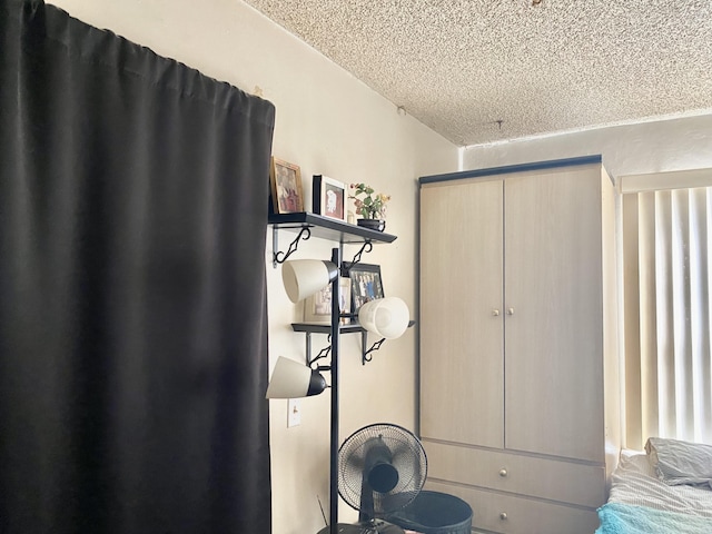 bedroom with a textured ceiling and a closet