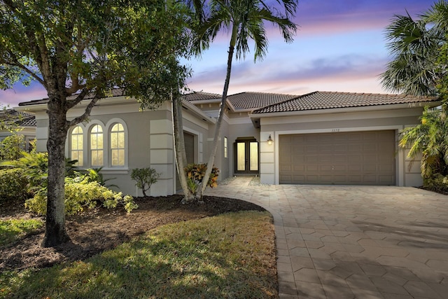 mediterranean / spanish-style home featuring a garage