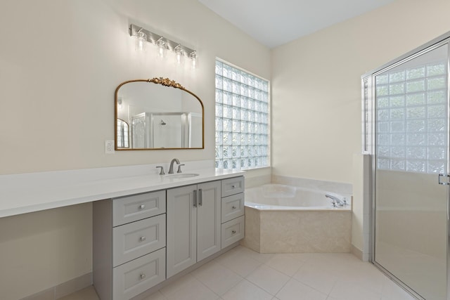 bathroom featuring tile patterned flooring, vanity, and separate shower and tub