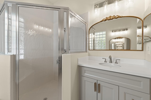 bathroom featuring vanity and a shower with door