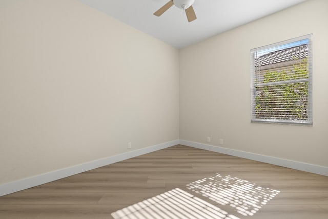 spare room with ceiling fan, light hardwood / wood-style floors, and lofted ceiling