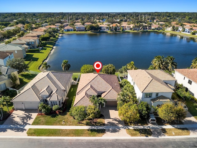 birds eye view of property with a water view