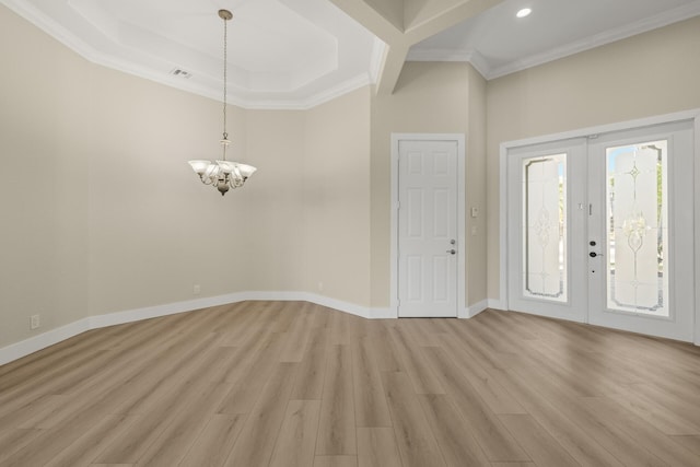 foyer featuring crown molding, french doors, a notable chandelier, and light hardwood / wood-style flooring